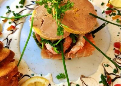 Exquisite dish at Table d'hôtes Bayeux: foie gras, seafood, and artistic sauce swirls. La ferme manoir saint barthélemy.