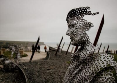 Metal sculpture at Normandy beach depicting a soldier, relevant to L'Histoire du Débarquement et de la Bataille de Normandie.