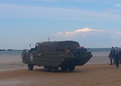 DUKW amphibious vehicle on a Normandy beach, a reminder of L'Histoire du Débarquement et de la Bataille de Normandie.