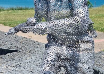 Metal sculpture of a soldier, likely related to L'Histoire du Débarquement et de la Bataille de Normandie.