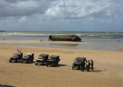 D-Day landing site in Normandy with vintage Jeeps; L'Histoire du Débarquement et de la Bataille de Normandie.