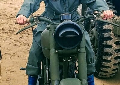 Boy on vintage motorcycle at Le D Day à la Ferme Manoir Saint Barthélemy.